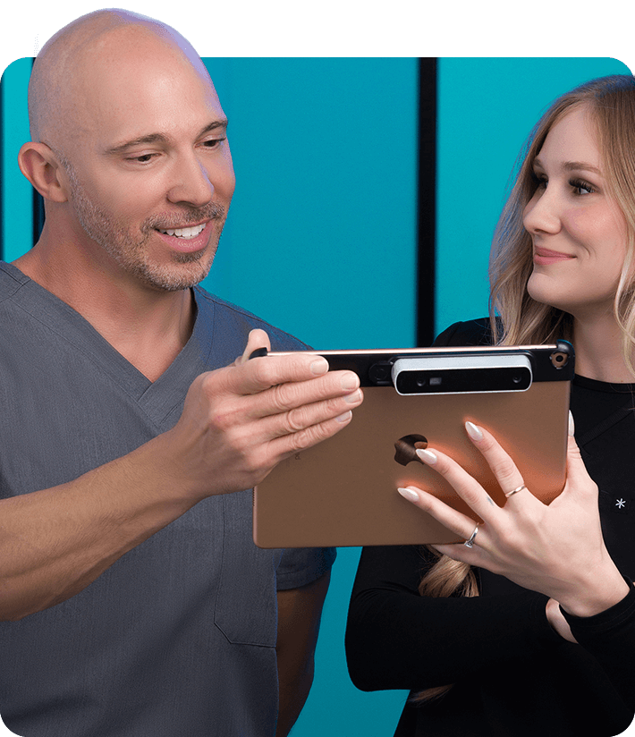 Dr. Beisinger reading documents with medical assistant.